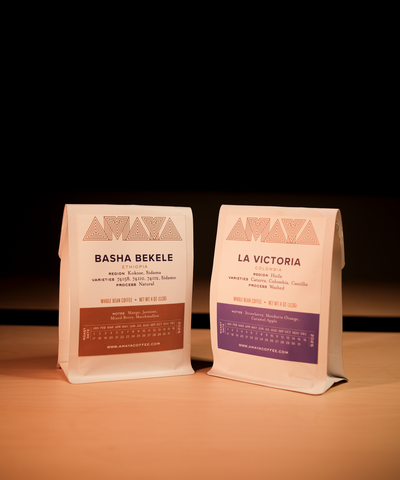 Two coffee bags from Amaya Coffee on a dark background